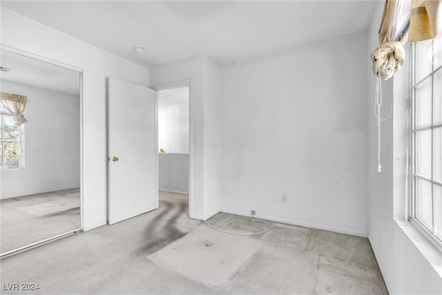 interior space with light carpet and a closet