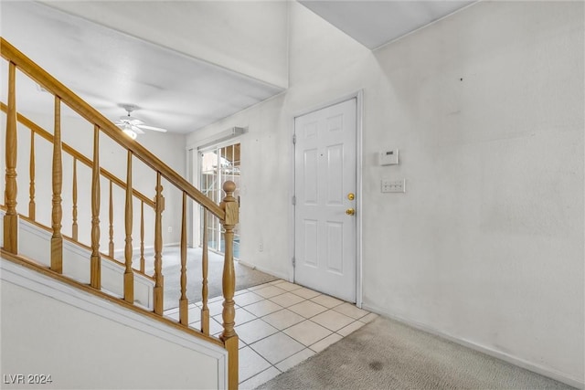 entrance foyer with light colored carpet and ceiling fan