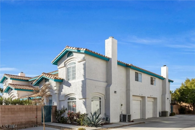 view of front of property with central AC and a garage