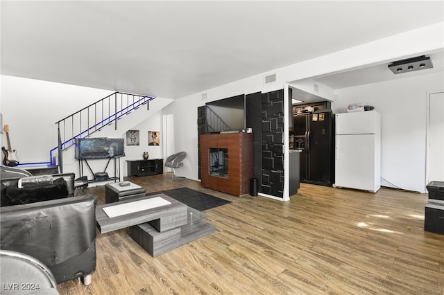 living room featuring hardwood / wood-style flooring and a fireplace