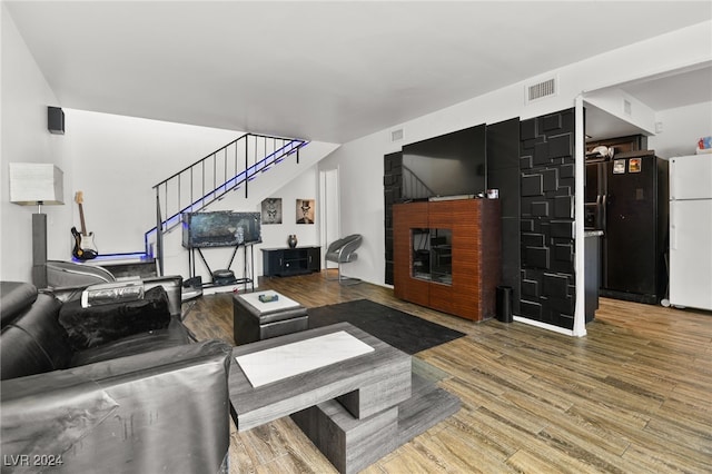 living room featuring hardwood / wood-style floors and a fireplace