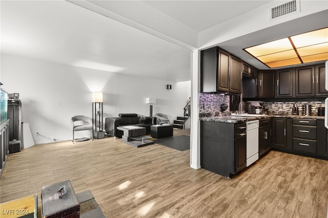 kitchen with sink, dark brown cabinets, white dishwasher, light hardwood / wood-style floors, and decorative backsplash