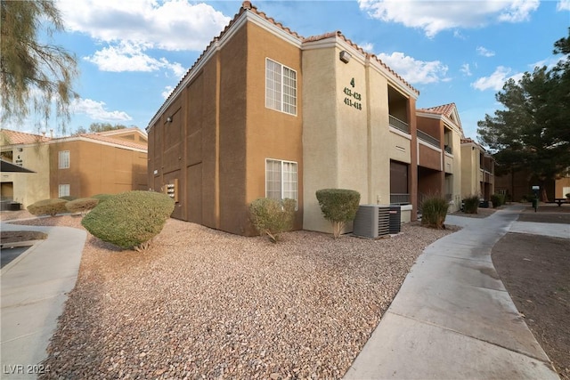 view of building exterior with central AC unit