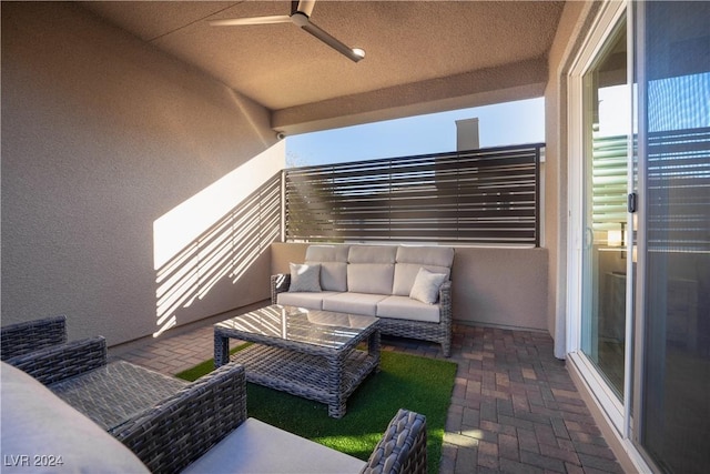 balcony with an outdoor living space and ceiling fan