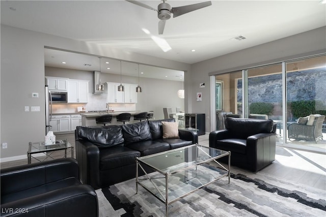 living room with sink and ceiling fan