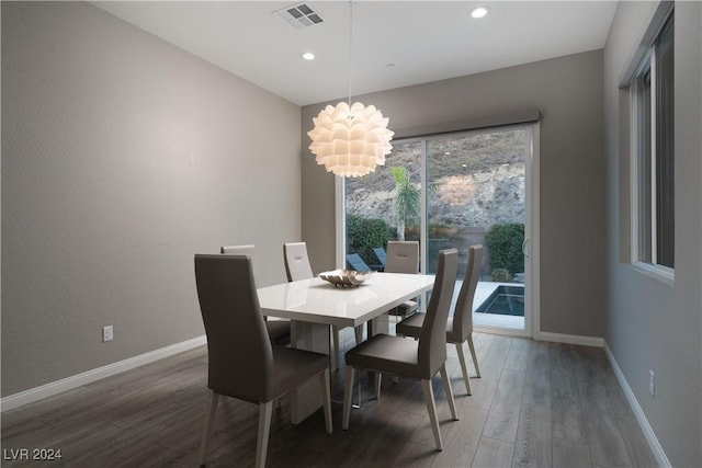 dining space featuring an inviting chandelier and wood-type flooring