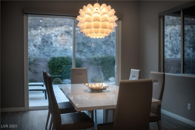 dining space featuring a chandelier and wood-type flooring