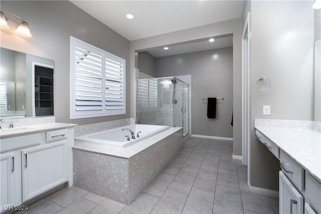 bathroom with tile patterned floors, vanity, and independent shower and bath