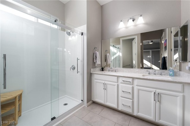 bathroom with tile patterned floors, vanity, and an enclosed shower