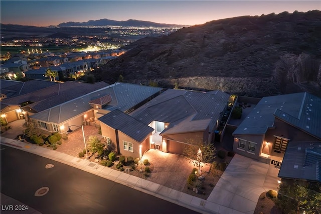 aerial view at dusk featuring a mountain view