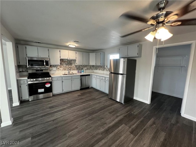 kitchen with dark hardwood / wood-style floors, gray cabinets, sink, and stainless steel appliances