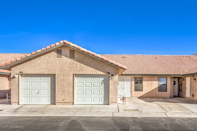 view of front of property featuring a tile roof and stucco siding