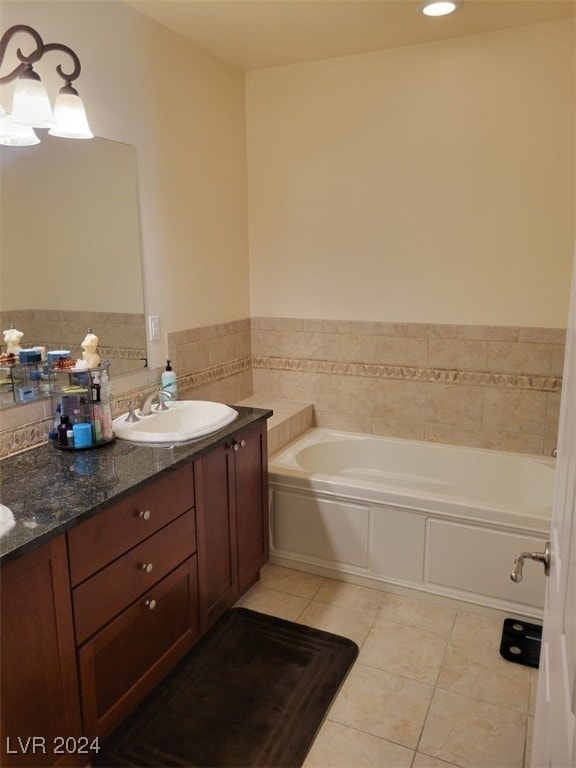 bathroom featuring tile patterned floors, a tub to relax in, and vanity