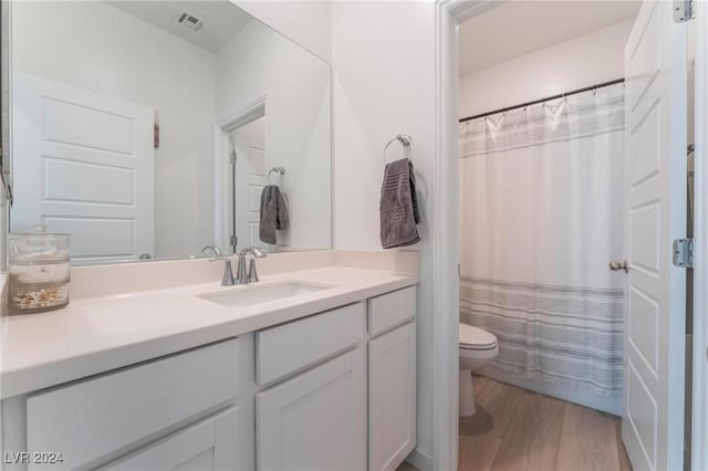 bathroom featuring hardwood / wood-style floors, vanity, and toilet