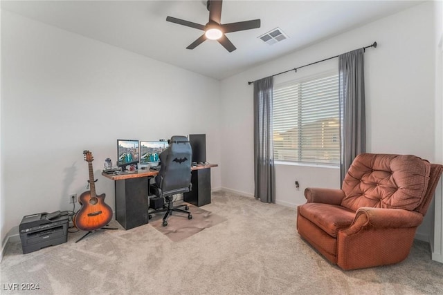 carpeted office featuring ceiling fan