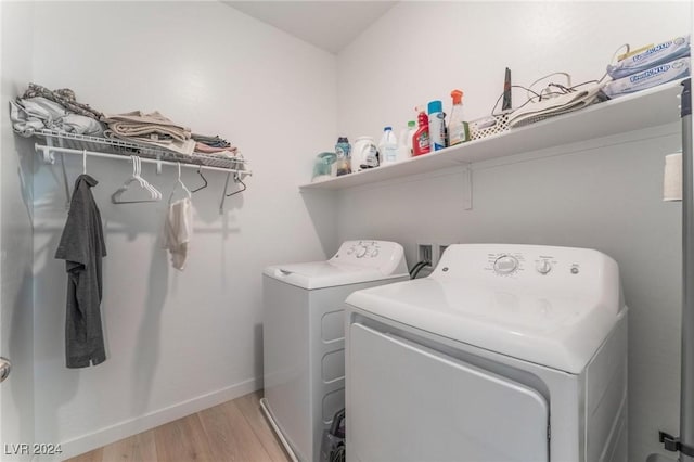laundry area featuring washer and dryer and light wood-type flooring