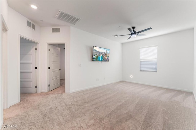 interior space featuring ceiling fan and light colored carpet