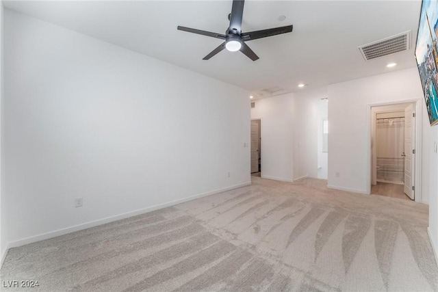 unfurnished room featuring ceiling fan and light colored carpet