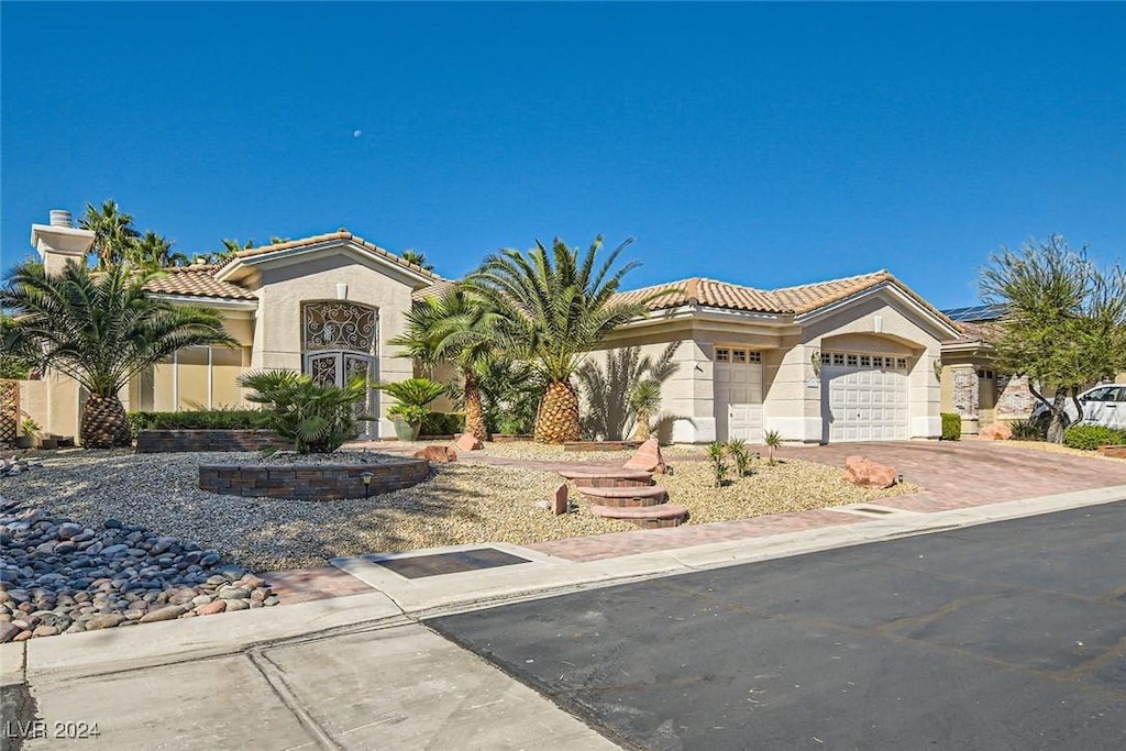 mediterranean / spanish-style house with a garage