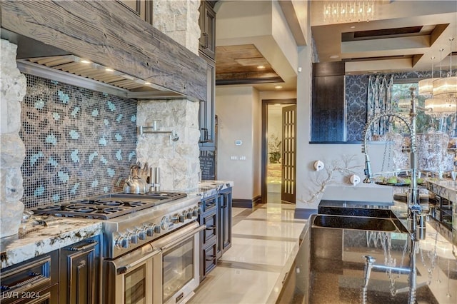 kitchen featuring light stone countertops, dark brown cabinets, premium range hood, and high end stainless steel range oven