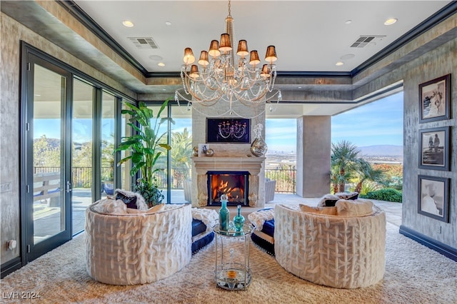 living room featuring a chandelier and ornamental molding