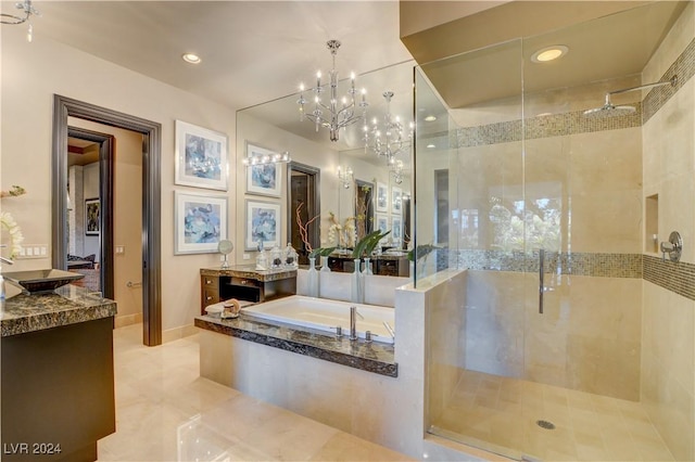 bathroom featuring tile patterned floors, vanity, an inviting chandelier, and independent shower and bath