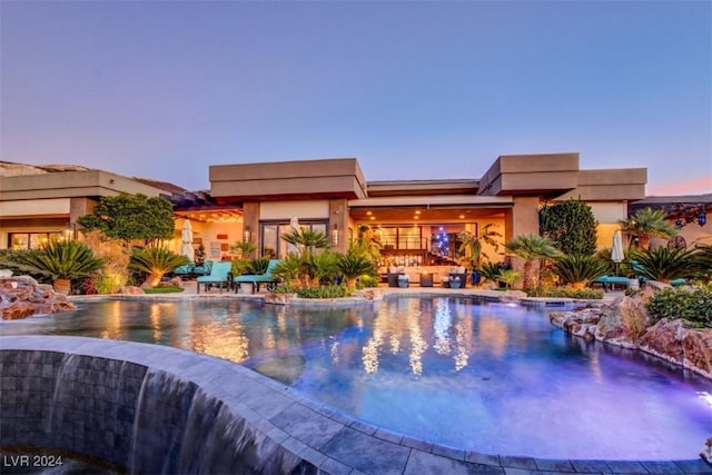 view of pool at dusk