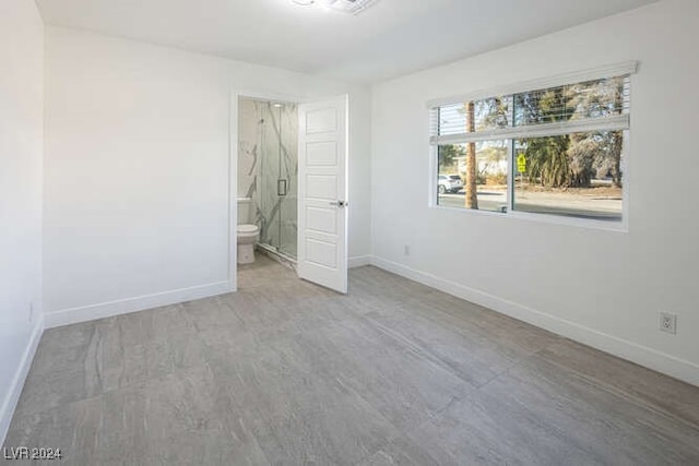 unfurnished bedroom featuring ensuite bathroom