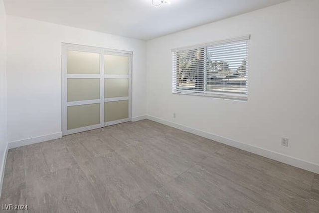 unfurnished room with wood-type flooring