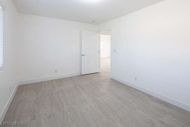 spare room with light hardwood / wood-style flooring