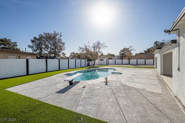 view of pool with a patio and a lawn