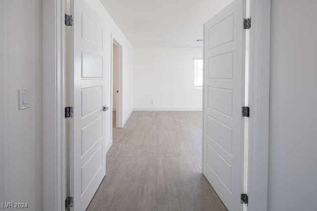 hall with light hardwood / wood-style flooring