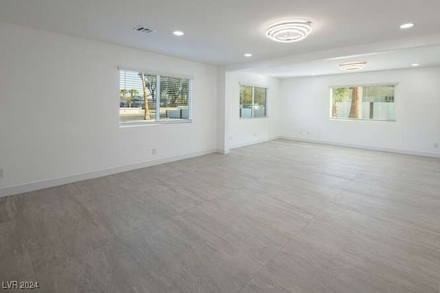 spare room featuring hardwood / wood-style floors and plenty of natural light