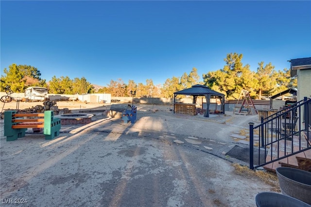 view of street with driveway, stairway, and a gated entry