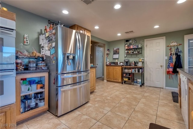 kitchen with light tile patterned floors, visible vents, stainless steel refrigerator with ice dispenser, and recessed lighting