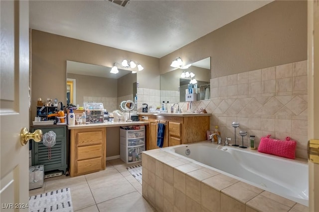 full bath with tile patterned flooring, a garden tub, and vanity