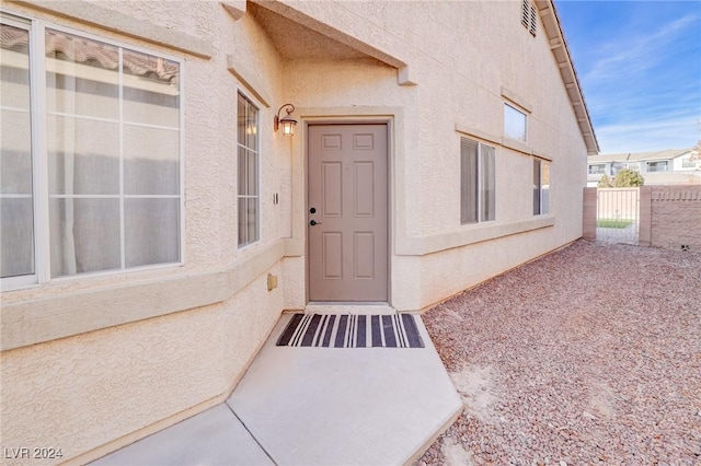 view of exterior entry with a patio