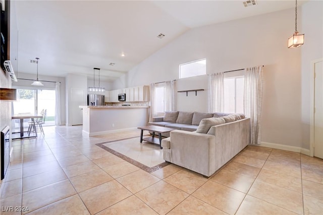 living room featuring light tile patterned floors and high vaulted ceiling