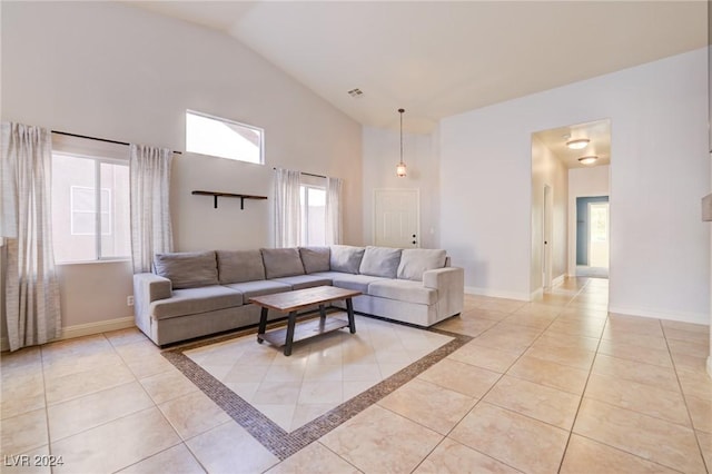 living room with light tile patterned flooring and vaulted ceiling