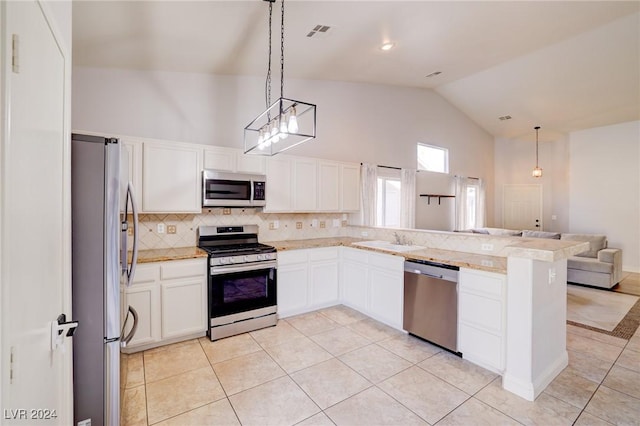 kitchen featuring kitchen peninsula, white cabinetry, hanging light fixtures, and stainless steel appliances