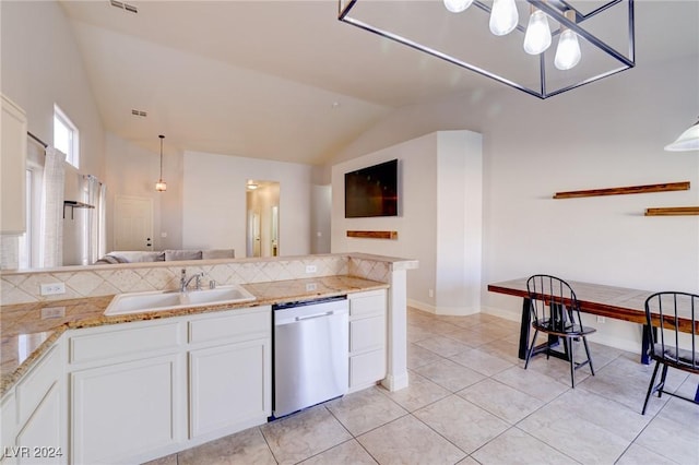 kitchen with sink, white cabinets, stainless steel dishwasher, lofted ceiling, and light tile patterned flooring