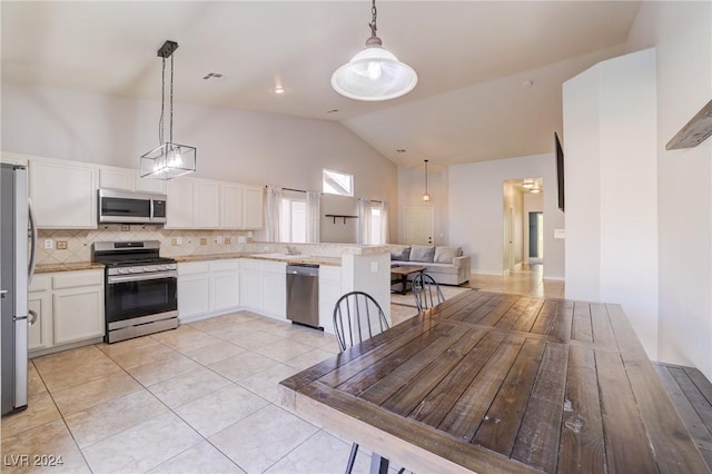 kitchen with decorative backsplash, appliances with stainless steel finishes, light tile patterned floors, decorative light fixtures, and white cabinetry