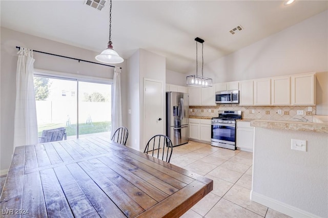 tiled dining room featuring high vaulted ceiling