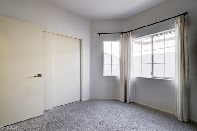 unfurnished bedroom with a closet and carpet