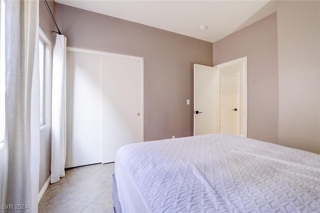 bedroom with light tile patterned floors