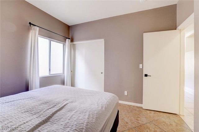 bedroom with light tile patterned floors