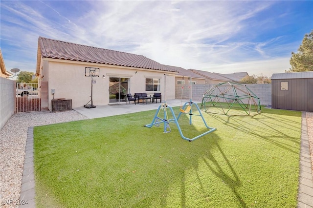 back of house featuring a shed, a yard, a patio, and central air condition unit