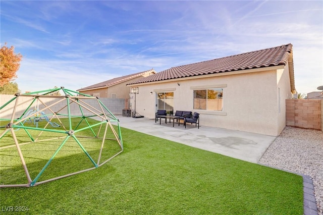 back of property with a patio area and a yard