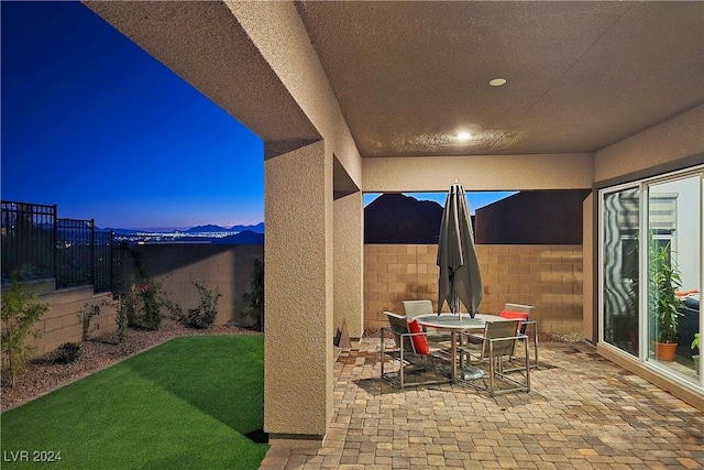 view of patio terrace at dusk