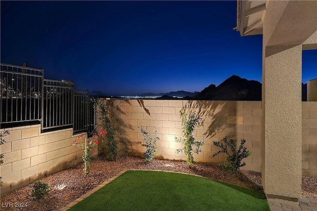 yard at night featuring a mountain view